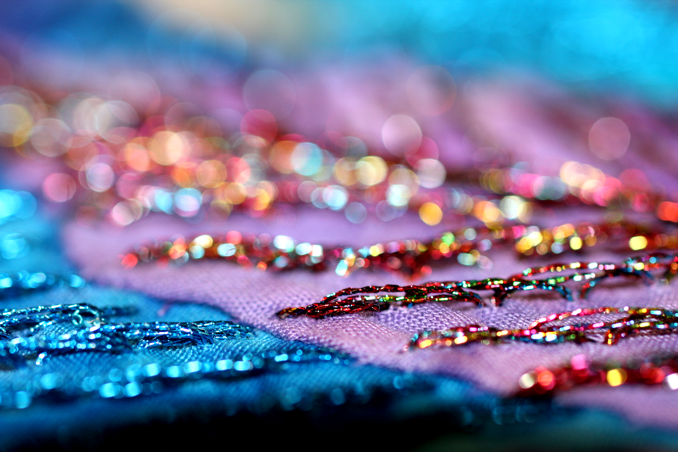 a pink cloth with multicolored sequins laying next to it