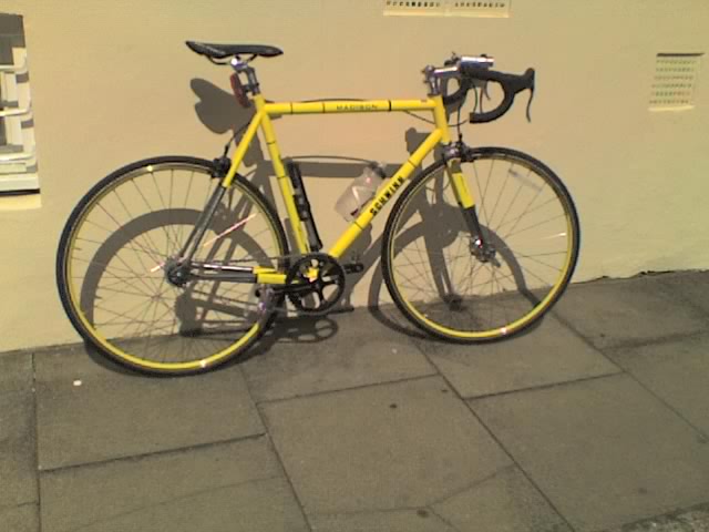 a yellow bike parked next to a white building