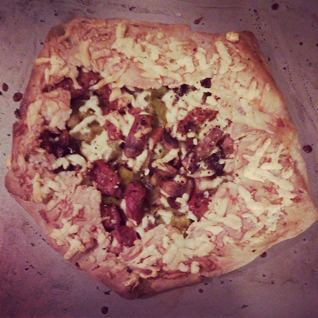 a square pizza sitting on top of a pan covered in toppings