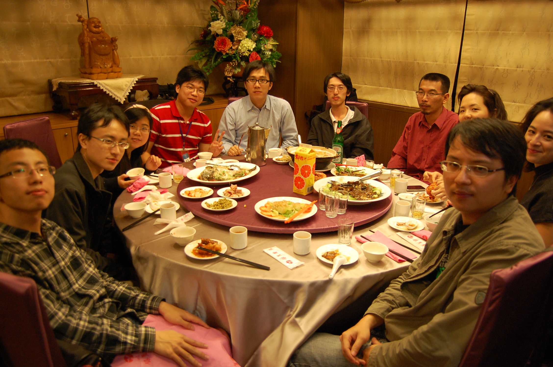 a group of people sitting around a round table