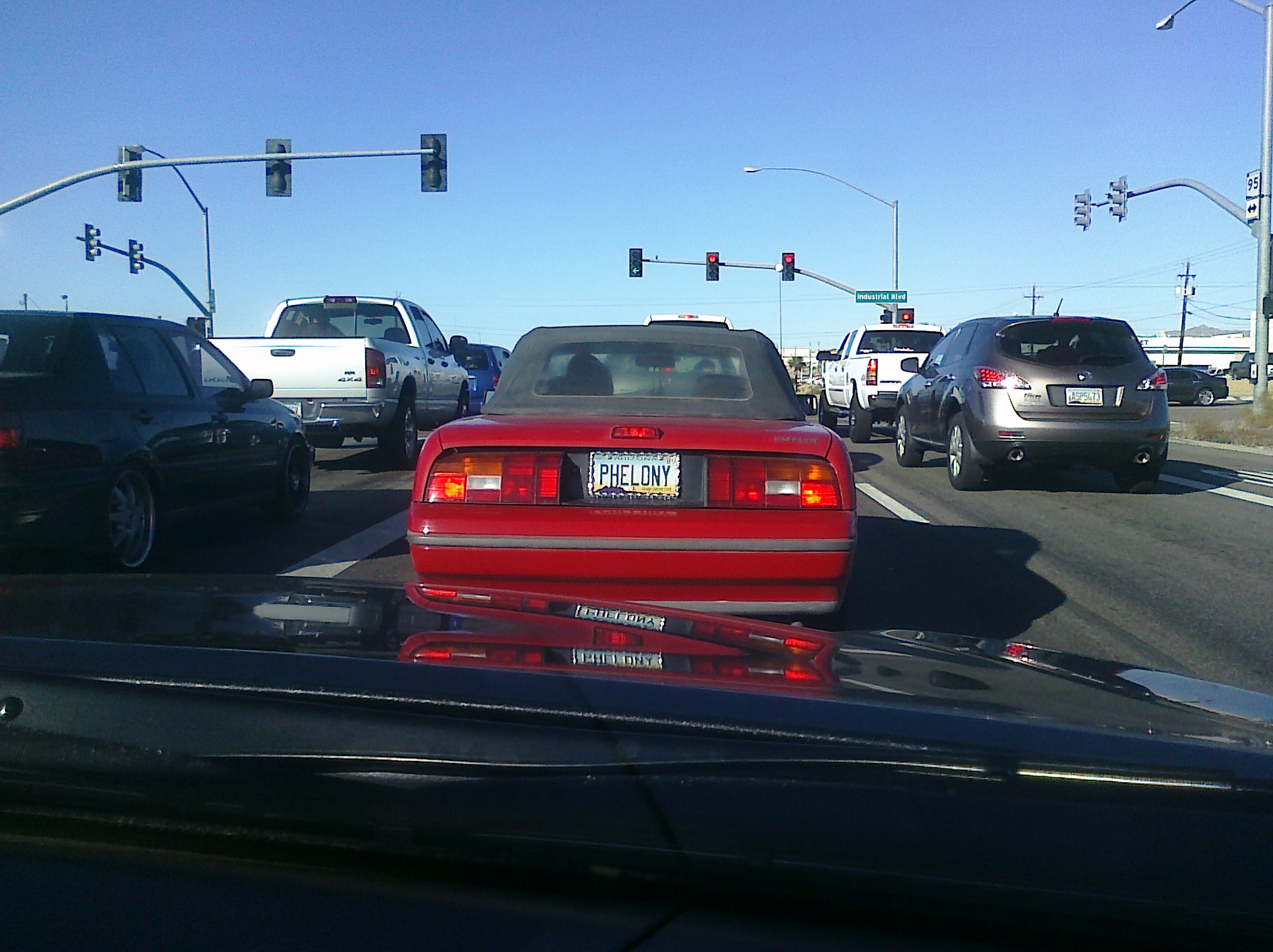 the cars are traveling on the road near stop lights