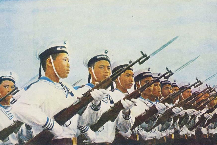 many asian people are wearing their uniforms and holding weapons