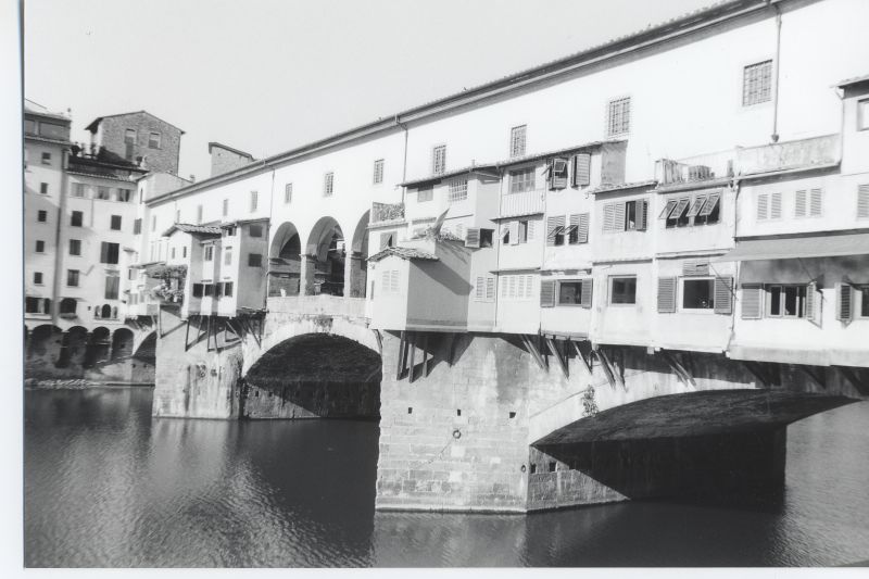 a bridge in the middle of a river in an old city