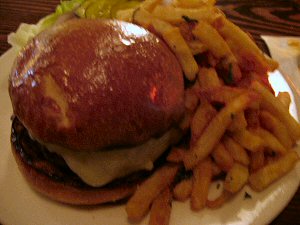 this hamburger with fries is on a plate