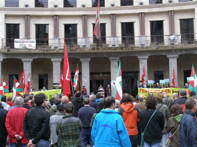 people gathering in front of building while carrying banners