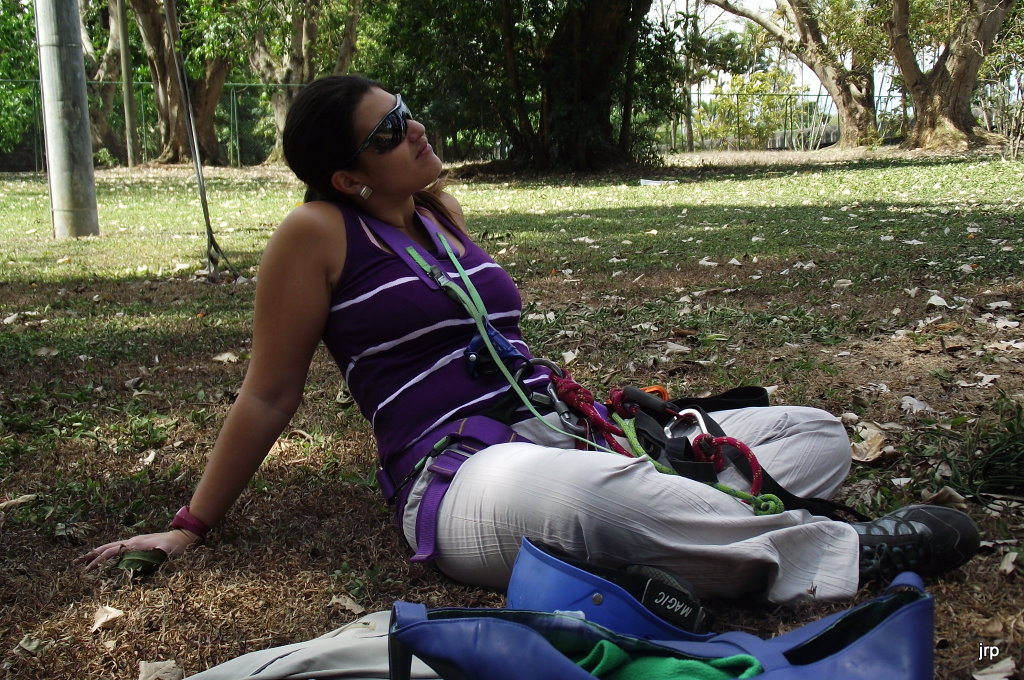 the lady sitting is wearing her gear on a camping trip