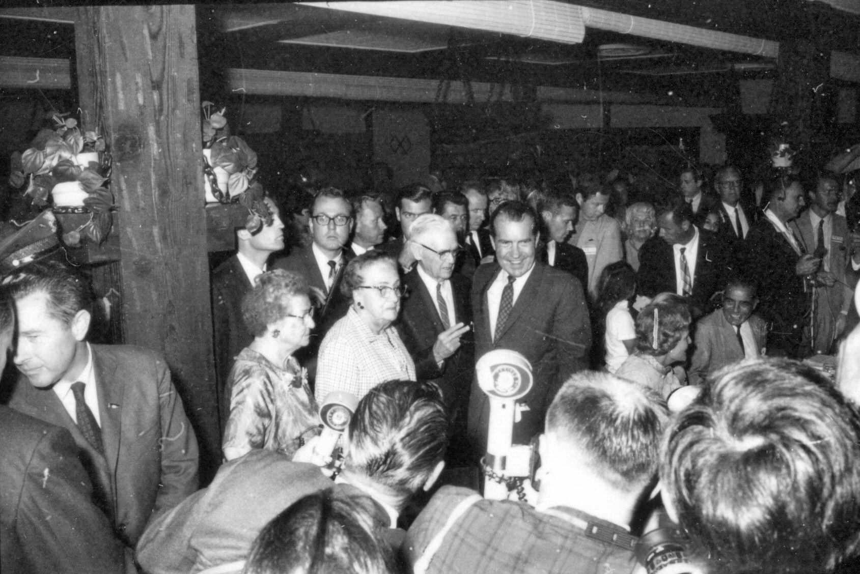 a group of people looking at a microphone