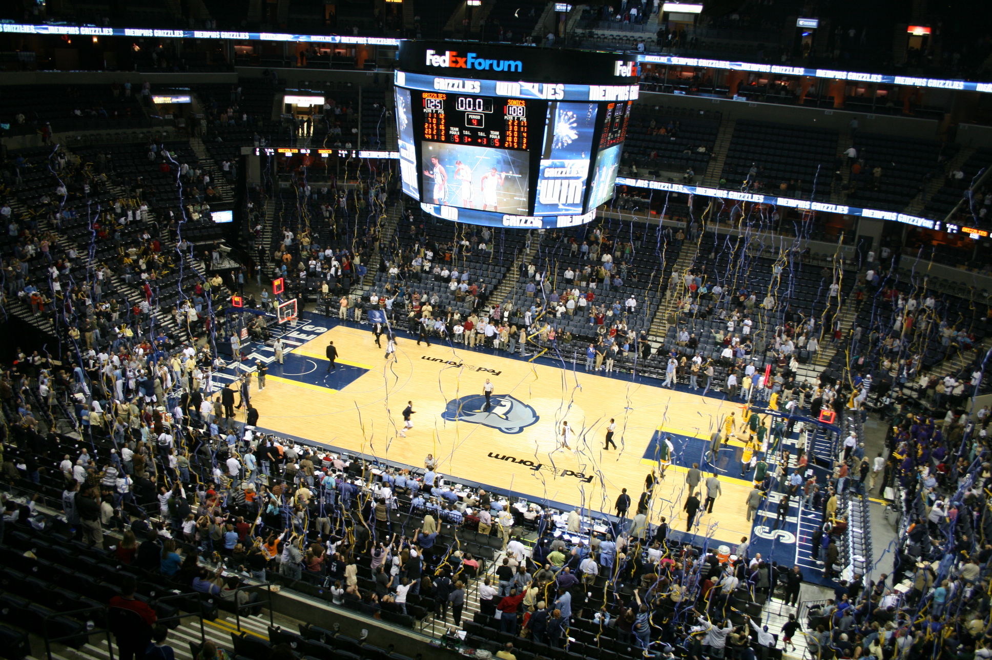 a view of a basketball court with fans in the stands