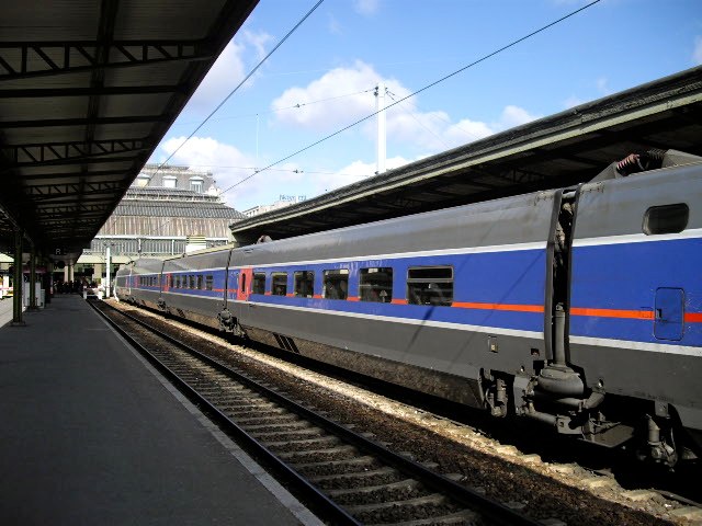 a passenger train at the station with it's doors opened
