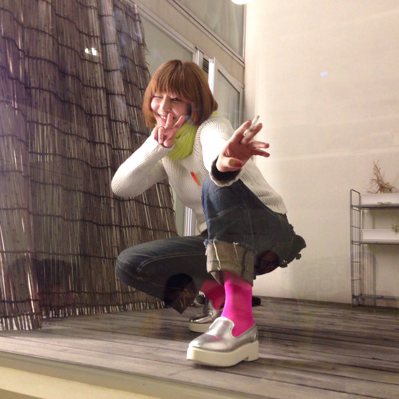 a young lady sitting on top of a wooden floor