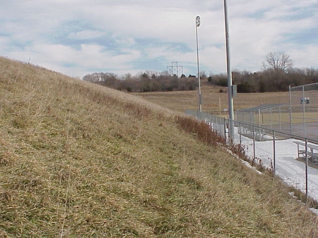an empty field with a baseball diamond on top