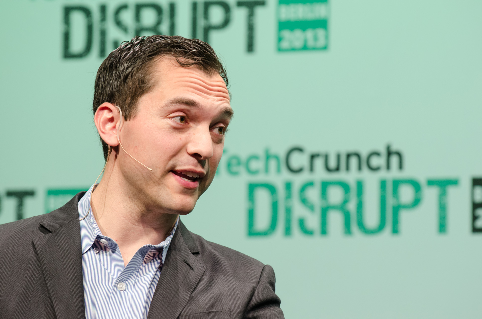 a man standing up at a conference speaking