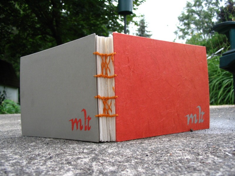 a red book that has some orange tape around it