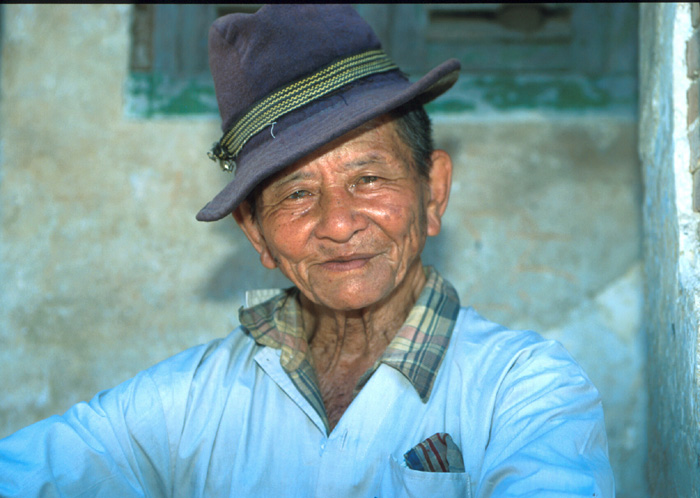 an old man in blue sweater and hat wearing a top hat