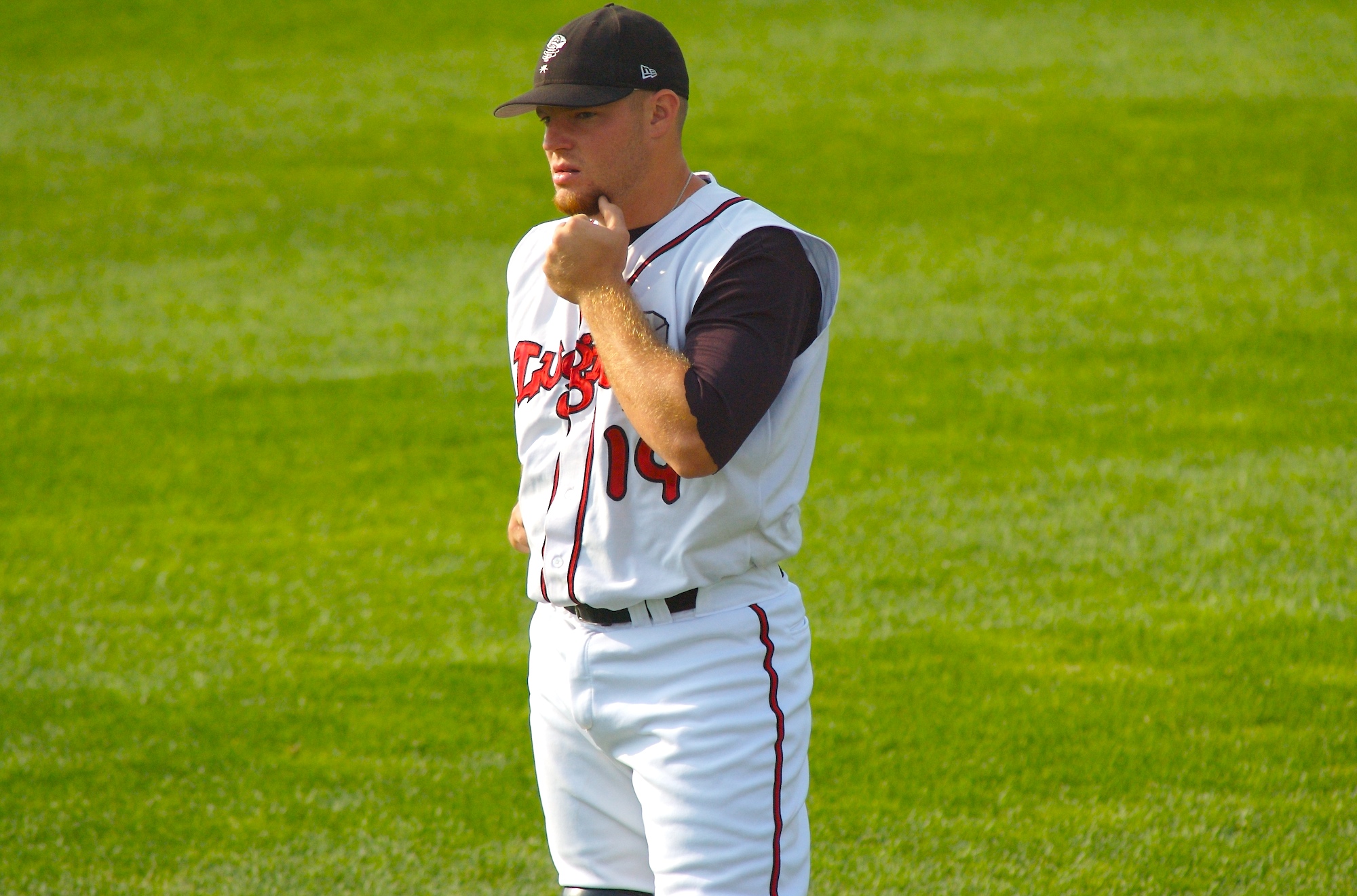 a baseball player is standing in the grass