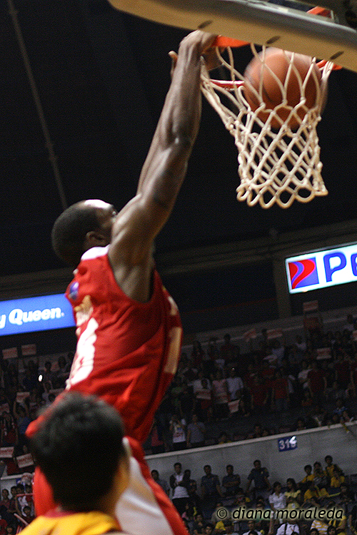 a basketball player jumps for a ball in the hoop