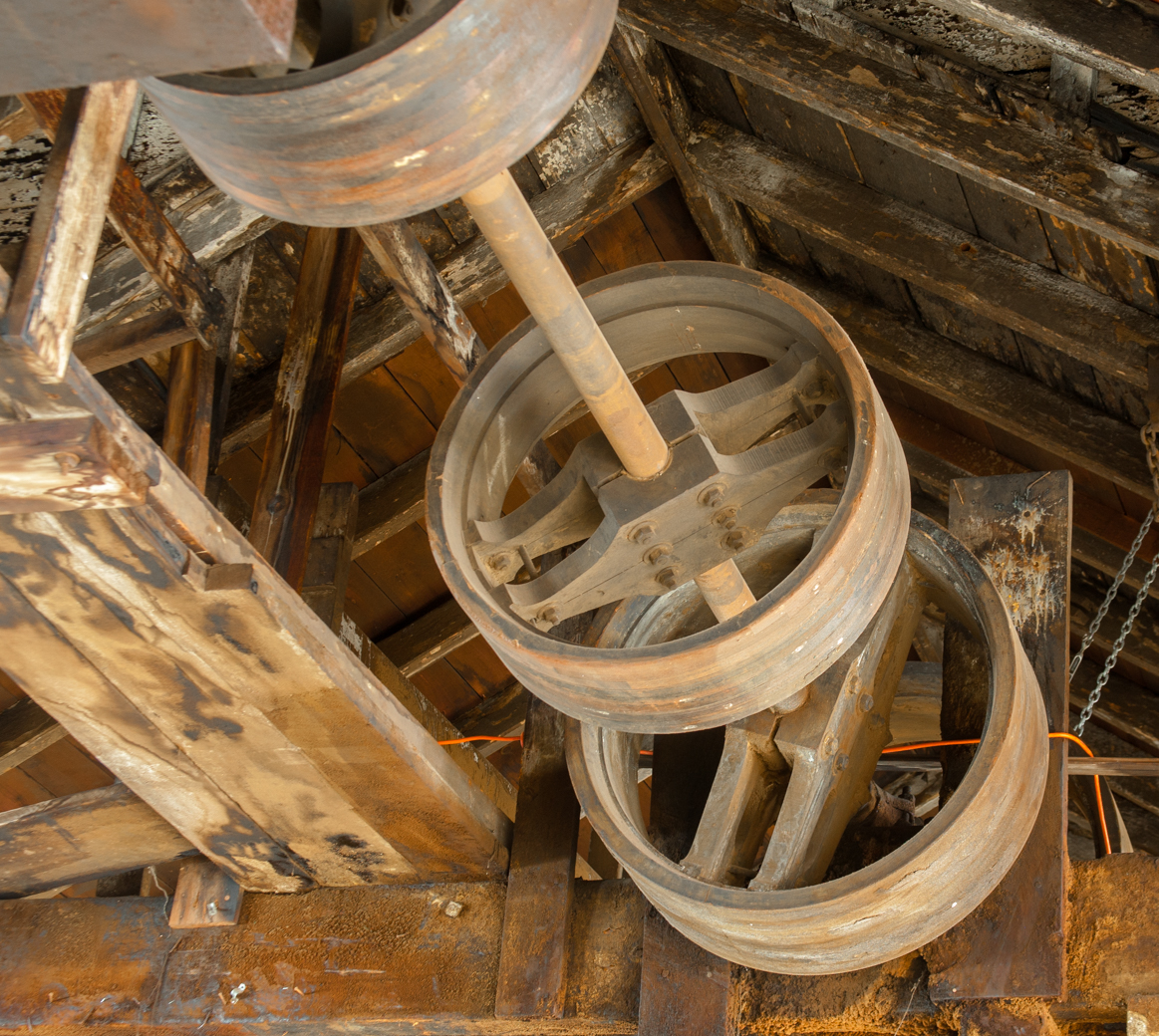 the broken steel wheels of an old machine in a shed