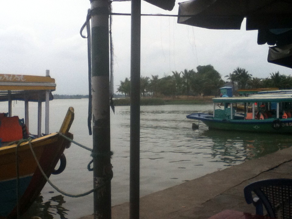 boats sit on the water with a dock in front