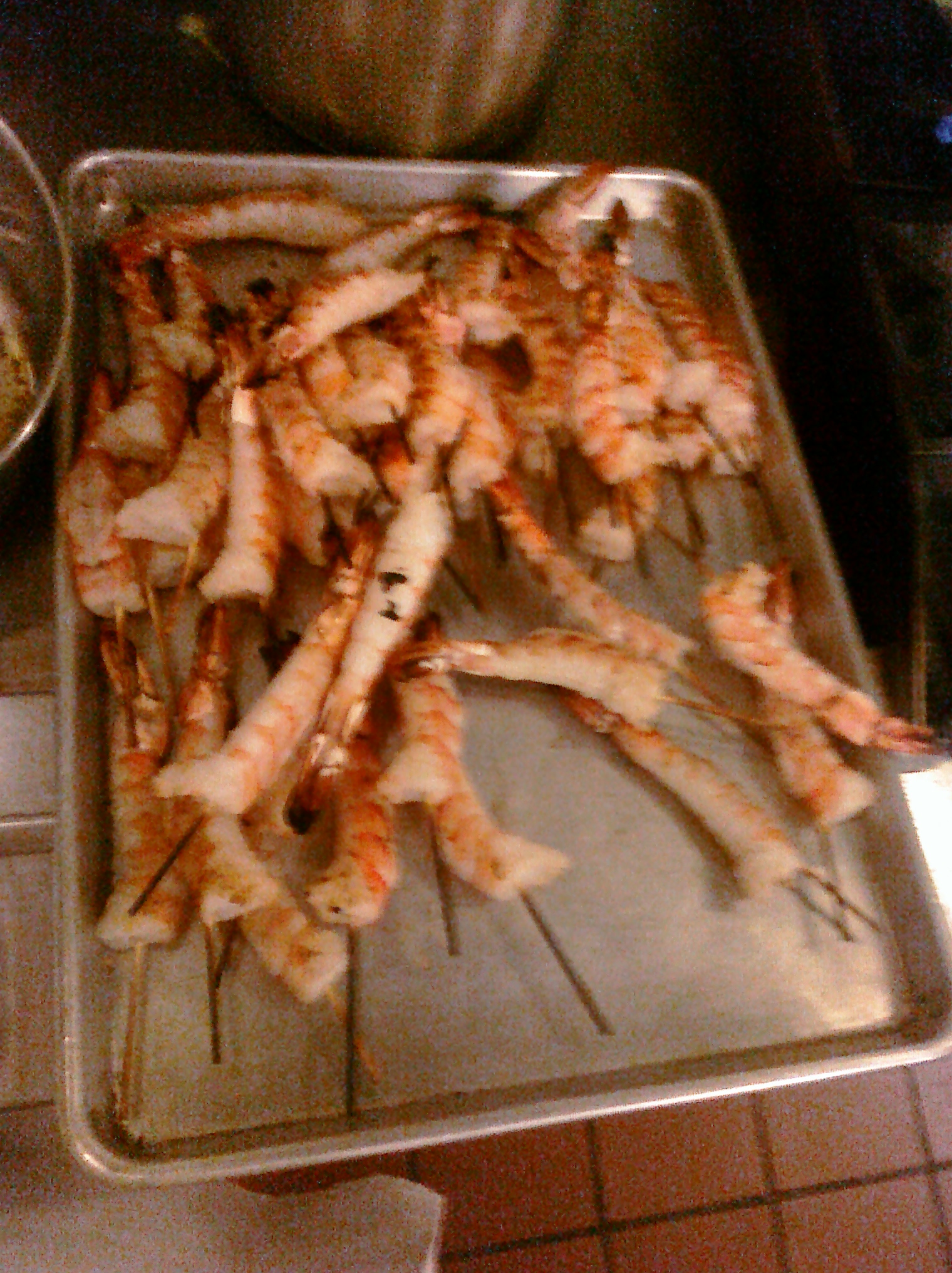 a tray of seafood cooking on top of a stove