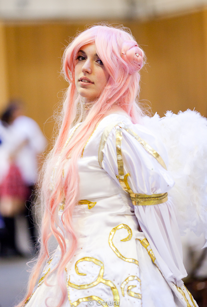 a woman with long hair and pastel pink wig wearing a fancy dress