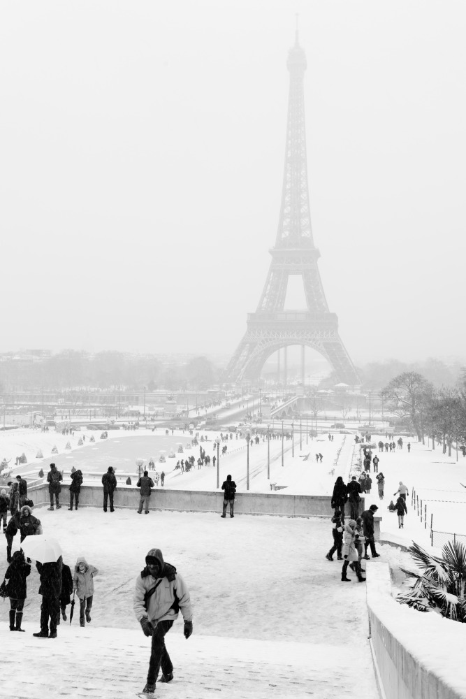 there are people walking around outside near the eiffel tower