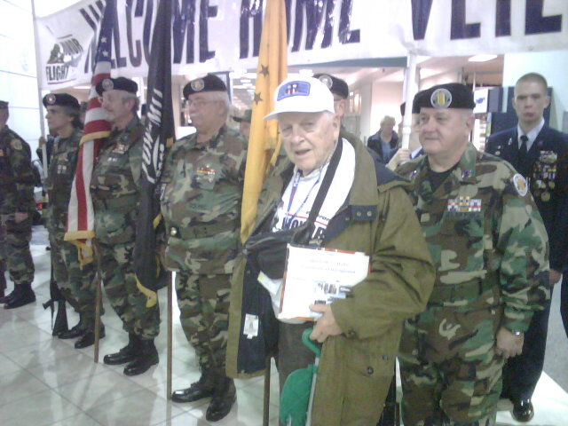 several military officers in uniforms standing on a marble floor