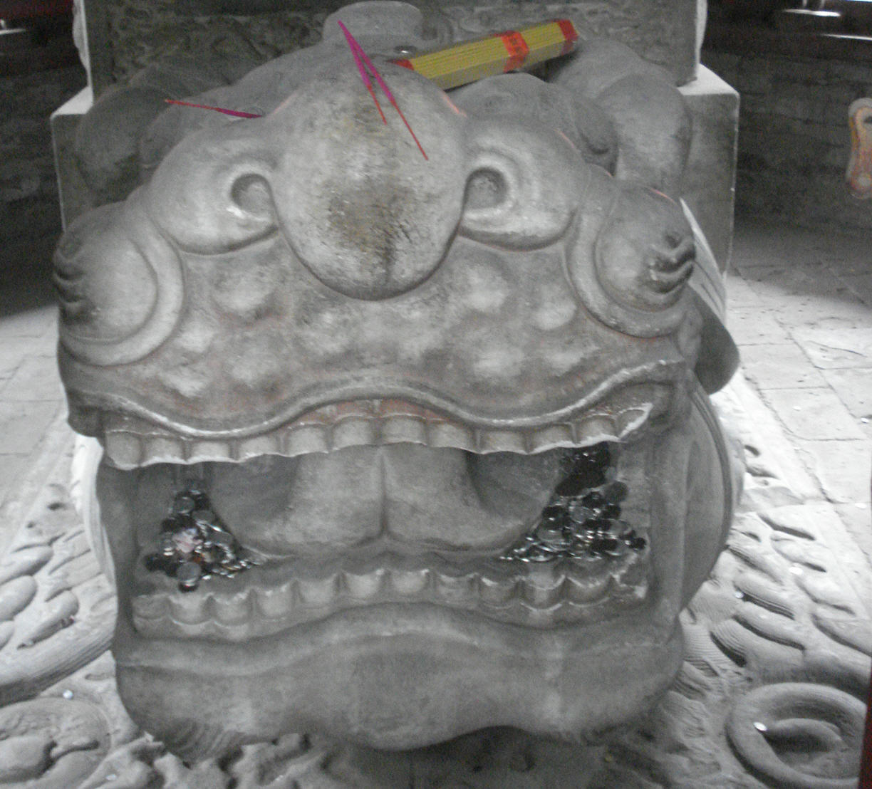 a stone dragon statue in the corner of a room