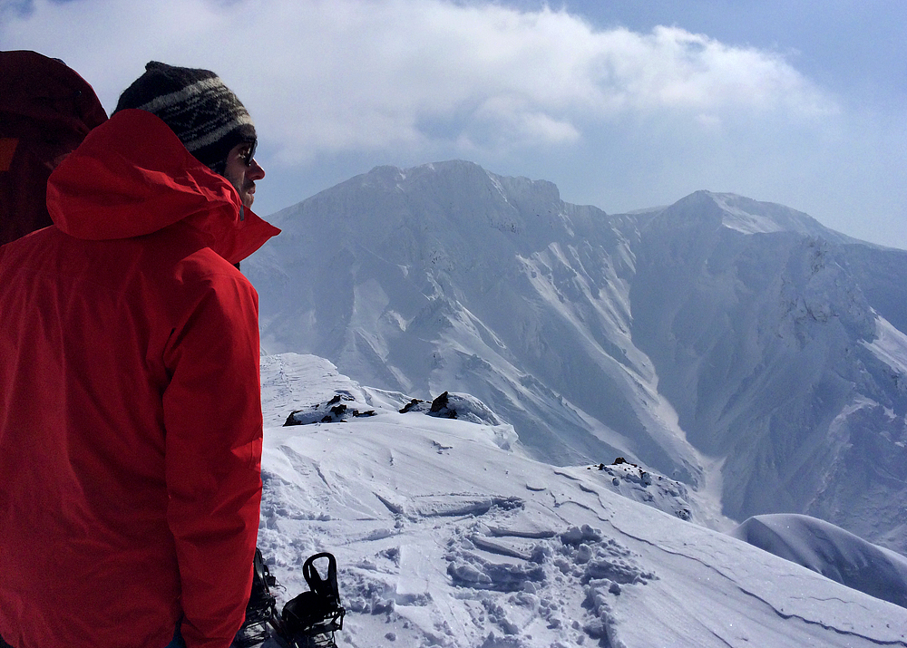 a person is looking at the snow on the mountains