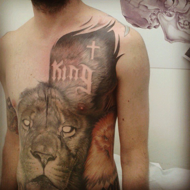 tattoos on man stomach with a lion and crown