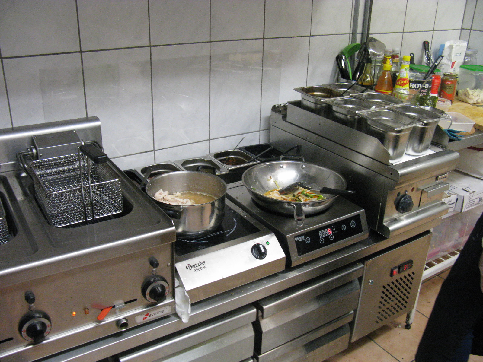 an industrial looking kitchen area with two burners