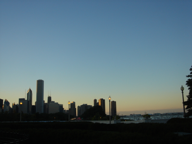 the skyline is lit up in the twilight