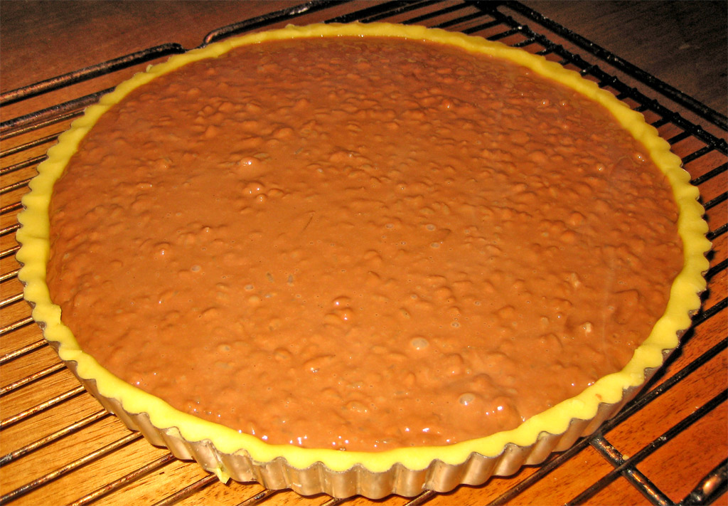 a chocolate pie on a wire rack with brown sugar