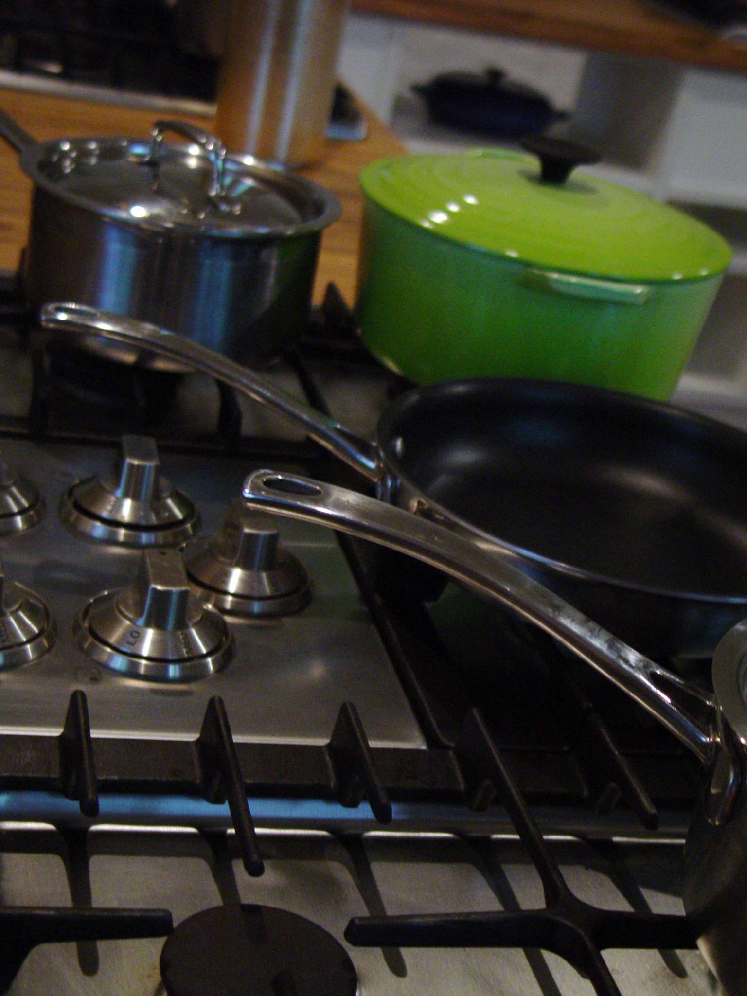 a view of a gas stove that has pans and a set on top of it
