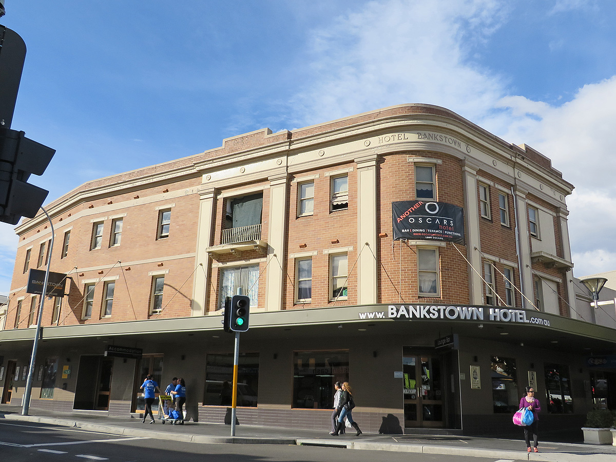 this is a large building with people walking down the street