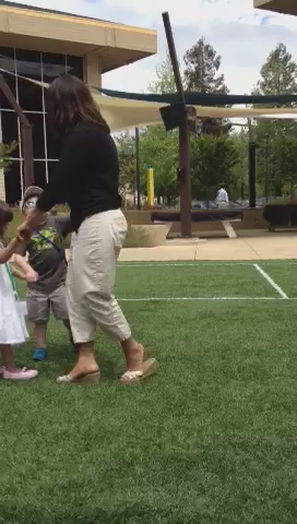 a woman is standing with two small children