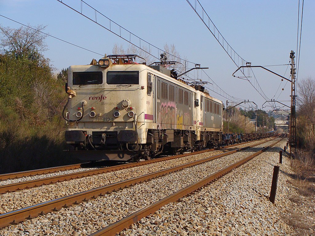 a white train traveling through a rural countryside