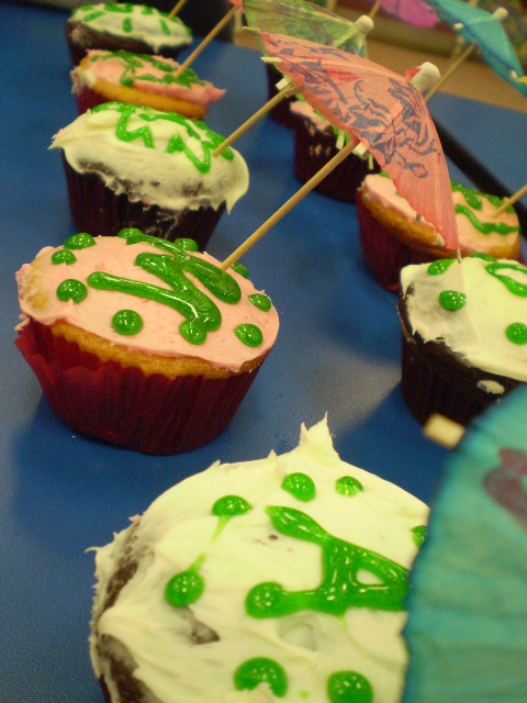 some cupcakes are decorated with green frosting