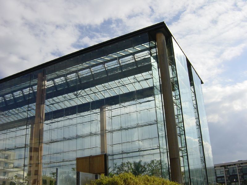 a large glass building with stairs in front