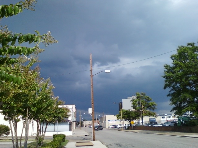 a dark colored sky over the street in a neighborhood