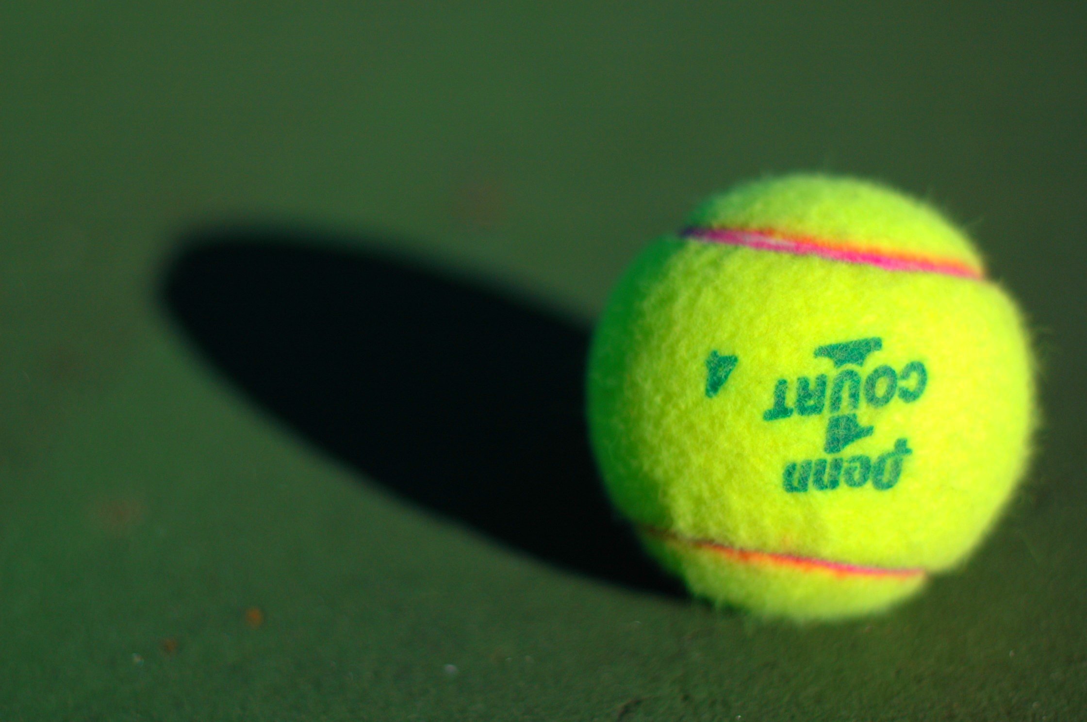 a tennis ball is laying on the court