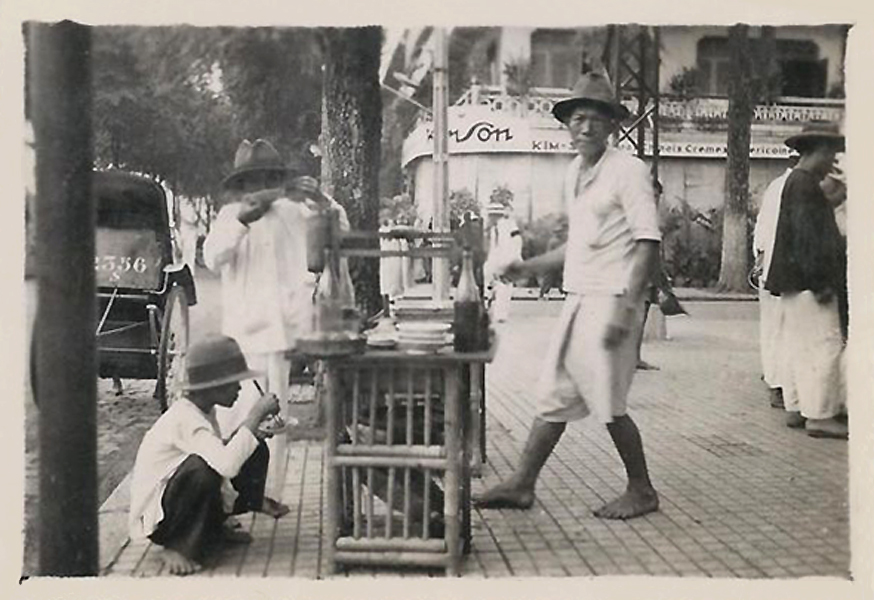 vintage pograph of men and women walking down a sidewalk