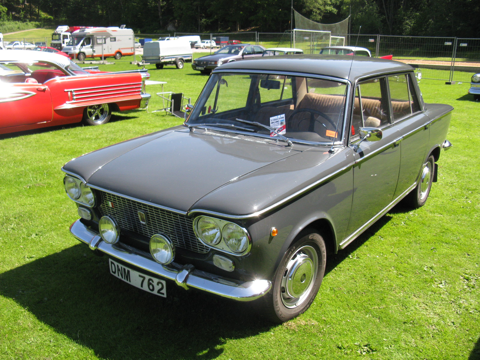 a grey and black car is in a field