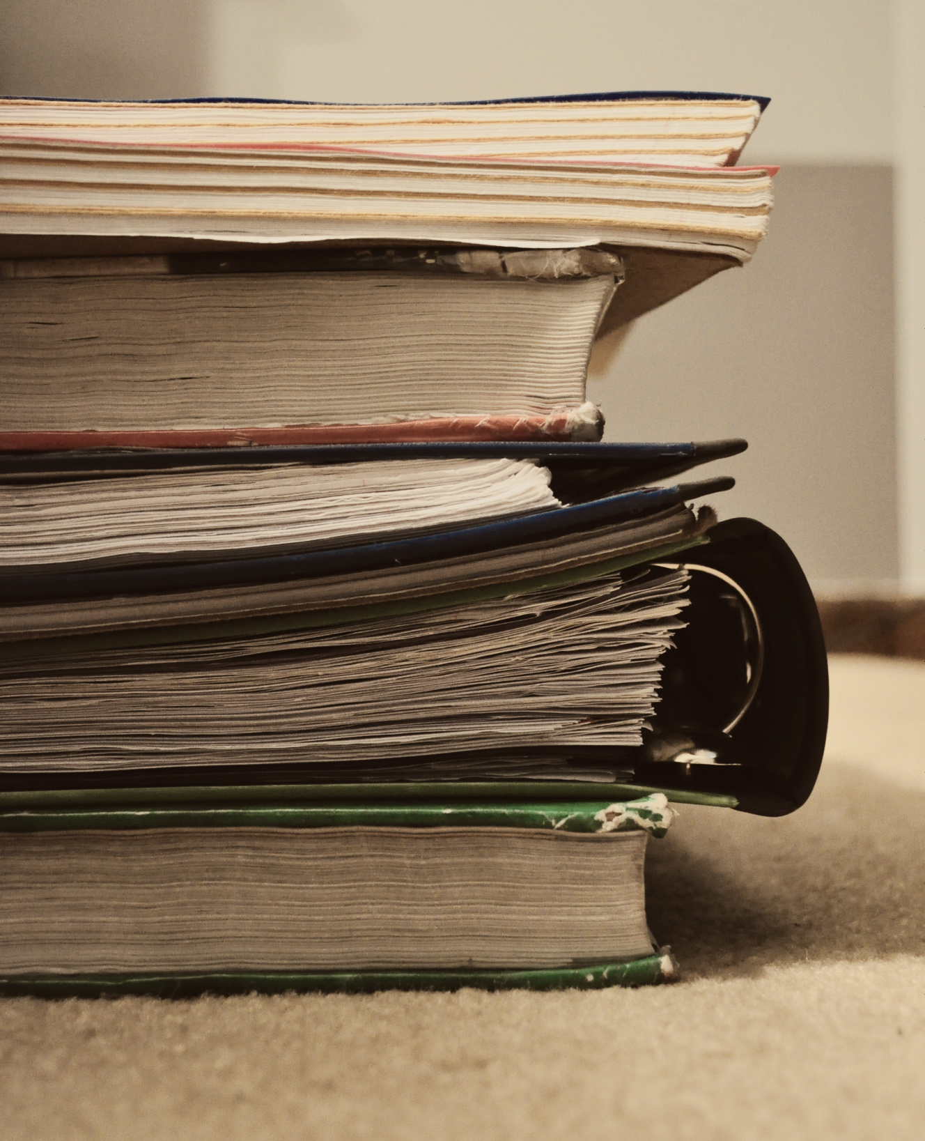 an assortment of different books stacked on top of each other