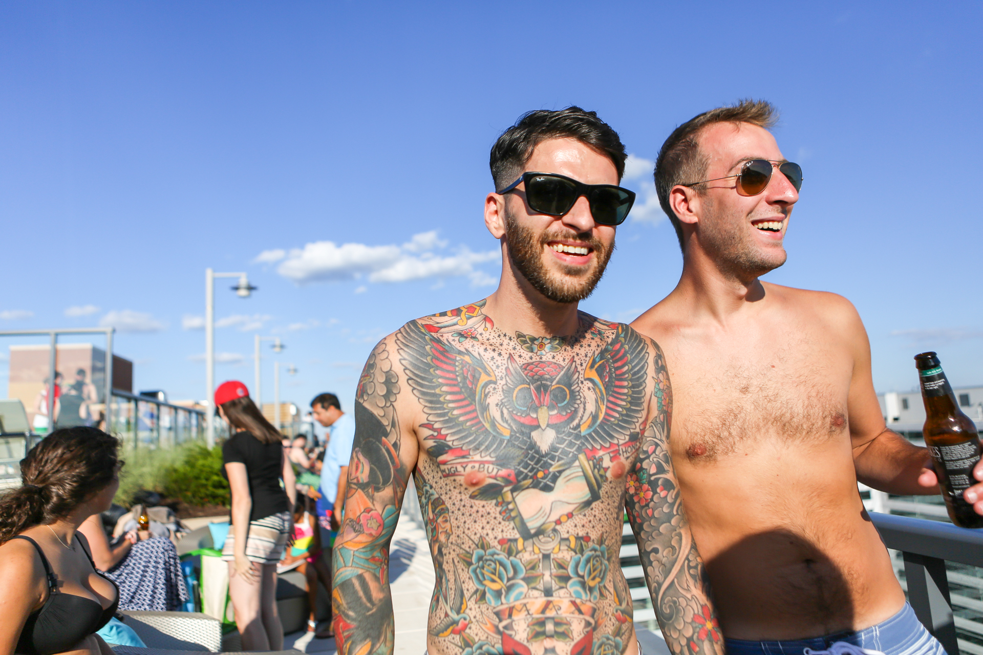 two men in sunglasses standing next to each other