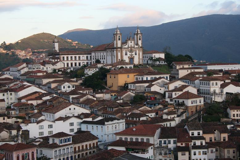 an old town with churches and hills in the background