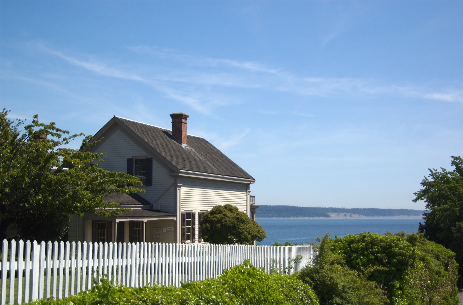 a house with a big deck and ocean view