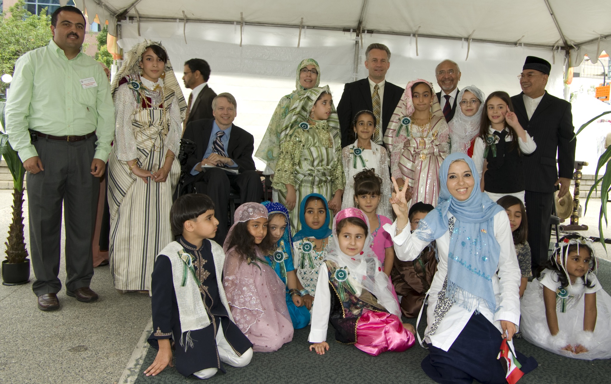 a group of children and adults all dressed up with a man