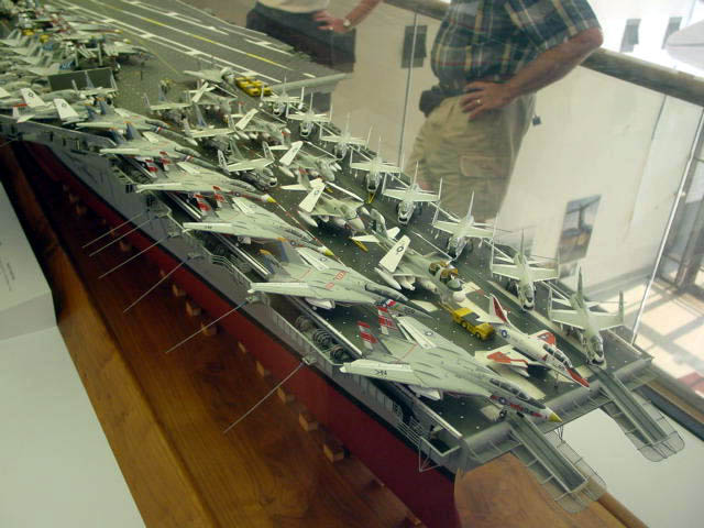 an assortment of models of military airplanes on display