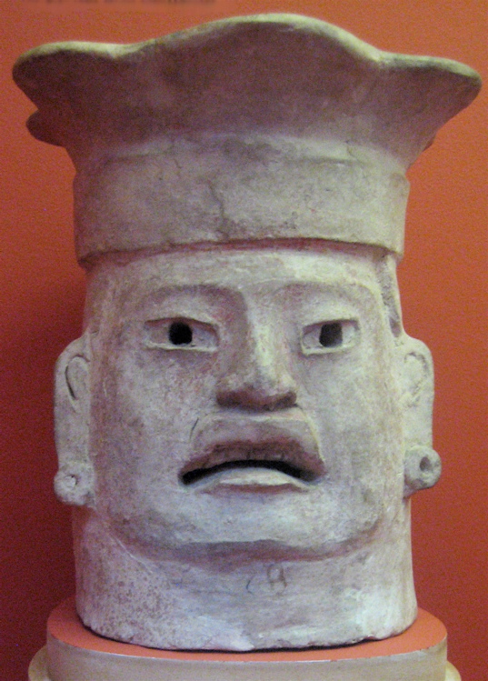 an old clay face is shown with a sad expression