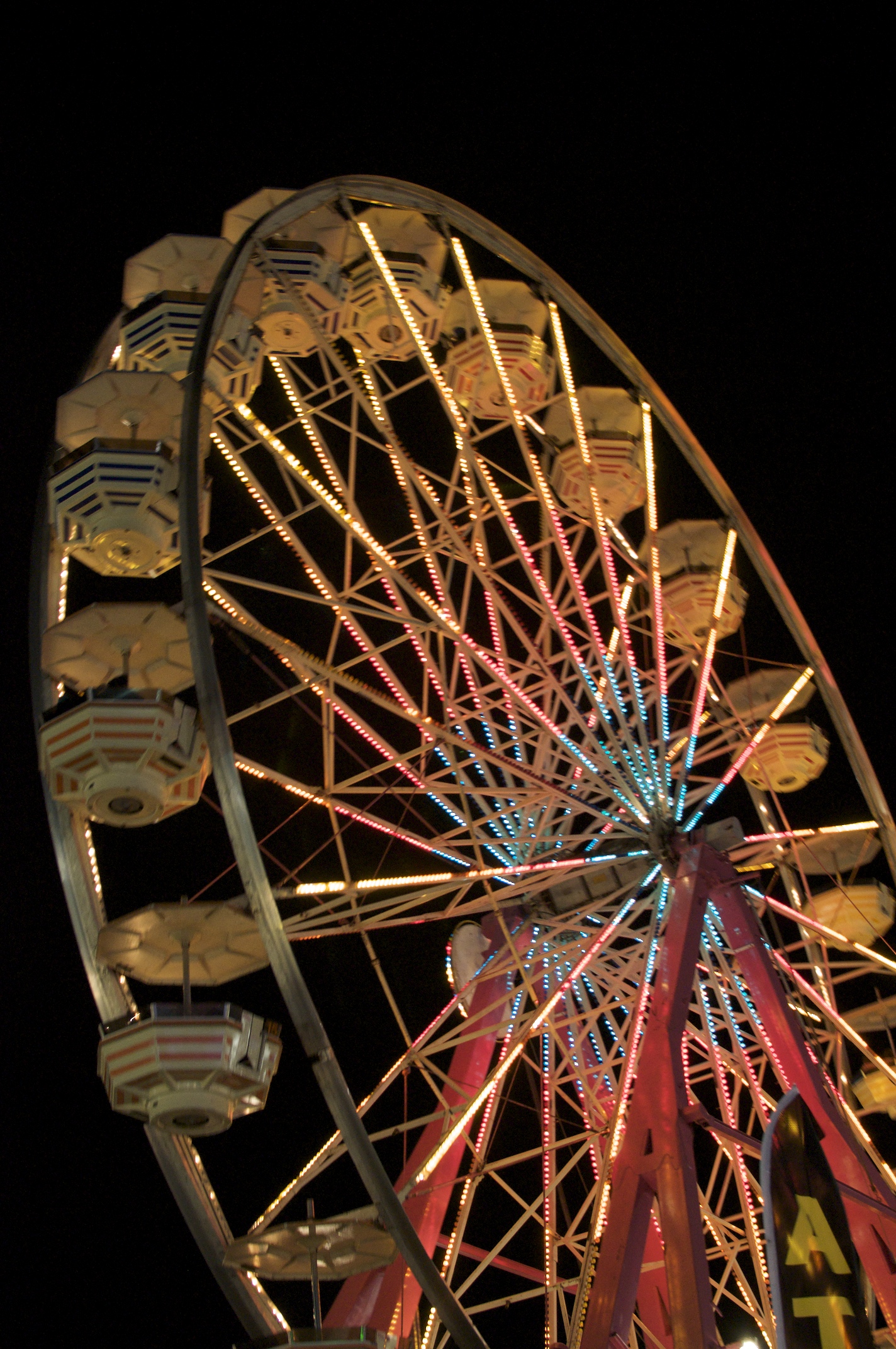 a ferris wheel lit up with lights at night